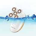 Veloura 3-in-1 electric razor for women, white body with rose-gold trim and five rotary shaving heads, on a plain background